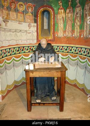 Monk scribe, writing a religious document. Exhibition concerning religion, Montjuic, Barcelona, Spain. Stock Photo