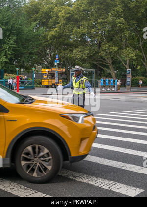 New York City, USA - September 8, 2018: Traffic police man is directing cars on roads in New York City. Stock Photo