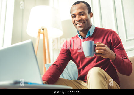 Happy young afro american man drinking coffee Stock Photo