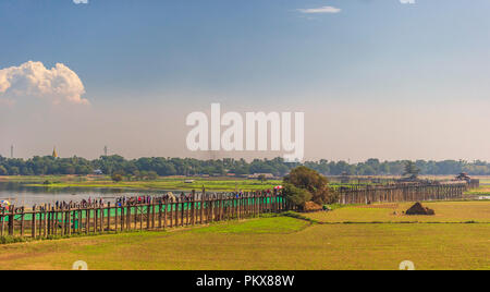 Colourful boats at U Bein Bridge on sunny day in Mandalay, Myanmar Stock Photo