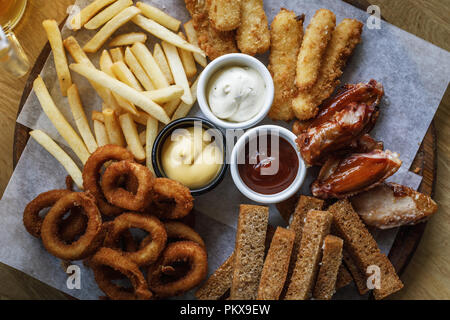 Large selection of snacks for beer. Top view of a tray with food Stock Photo