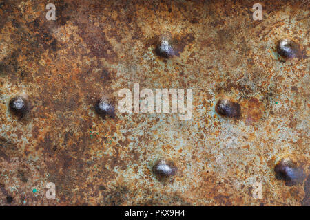Texture of a surface of a rusty metal sheet with bulges close-up Stock Photo