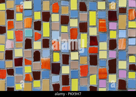Texture of small ceramic tiles of various shapes and colors. Background of a mosaic Stock Photo