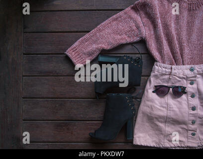 Autumn female outfit. Set of clothes, shoes and accessories on brown background. Fashion concept Stock Photo