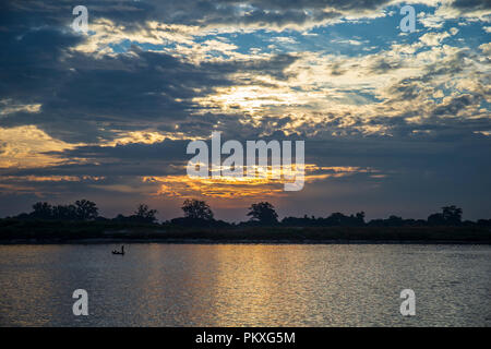 Dawn over the serene riverbanks of the Irrawaddy in Myanmar Stock Photo