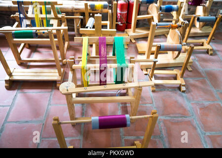 Wooden spools with colored silk threads. Stock Photo