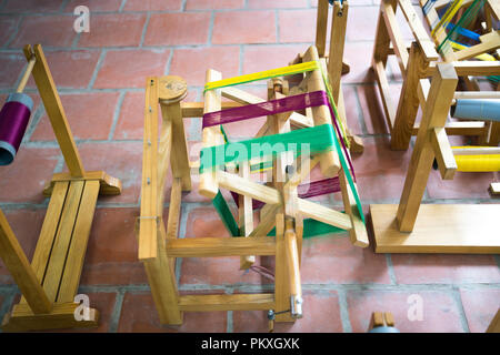 Wooden spools with colored silk threads. Stock Photo