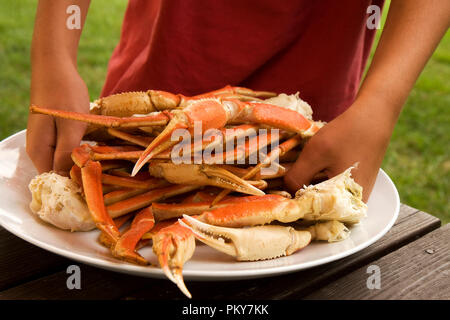 Large round plate with pile of King Crab Legs ready to eat. Stock Photo