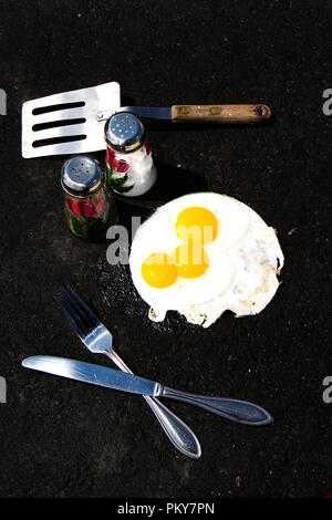 Eggs in carton with some broken.  Some images eggs frying on hot asphalt, concept. Stock Photo