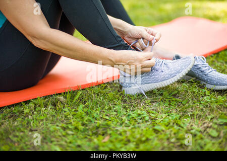 Close up view at woman wearing sport shoes at outdoor Stock Photo