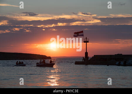 Croatian flag flying in wind at sunset in harbor Stock Photo