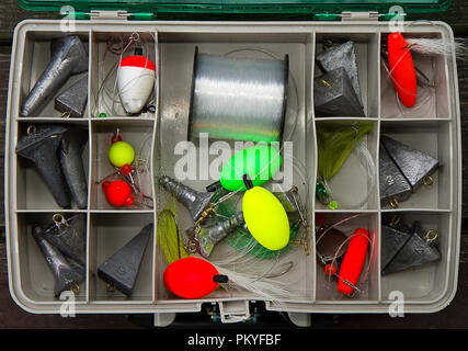 Inside tackle box of surf fishing weights and gear. Stock Photo