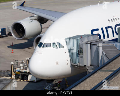 An Airbus A380 of Singapore Airlines during boarding at Zurich Kloten airport. Jettys on two deck levels connect the giant aircraft with the gate.