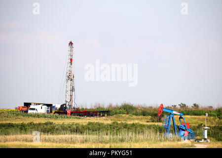 oil drilling rig and pump jack on oilfield Stock Photo