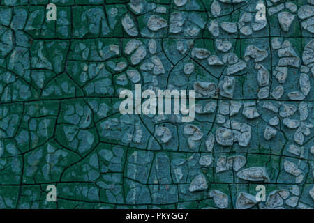 Macro photo. Texture of an old blue paint. Several layers. The concrete wall of the house was washed by rain. A good background for different sites. Stock Photo