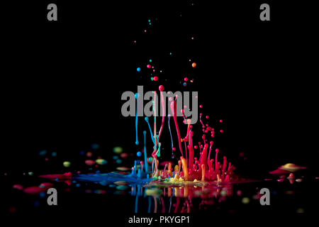 Abstract sculptures of colorful splashes of paint. Dancing liquid on a black background. Ink water splash. Color explosion. Stock Photo