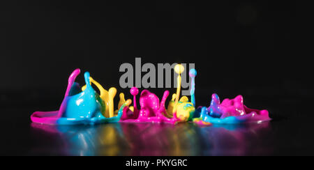 Abstract sculptures of colorful splashes of paint. Dancing liquid on a black background. Ink water splash. Color explosion. Stock Photo