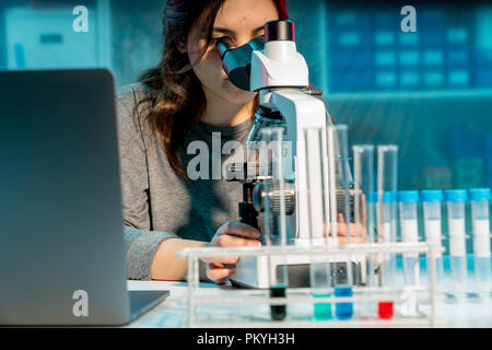 Female scientist researcher conducting an experiment in a laboratory Stock Photo