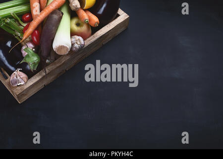 Local fresh raw vegetables in wooden box with copy space. View from above Stock Photo