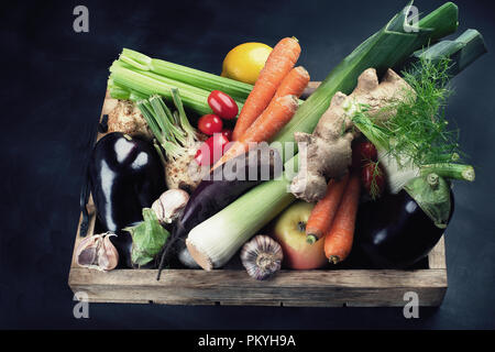 Local fresh raw vegetables in wooden box Stock Photo