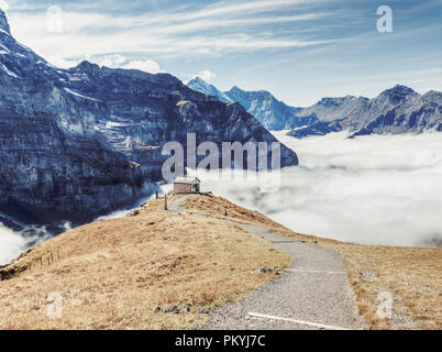 Tracking path of Eiger walk on top of the clouds from Jungfrau, Switzerland Stock Photo