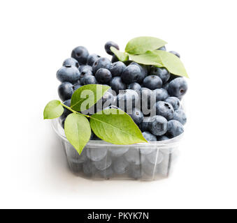 Fresh  blueberries in smal plastic container isolated on white Stock Photo