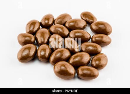 Chocolate covered nuts with selective focus isolated on white background - Close up horizontal image with space for text Stock Photo