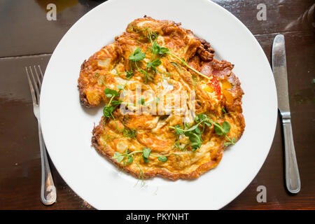 A vegetarian lunchtime meal a Spanish Omelette made with eggs and vegetables Stock Photo