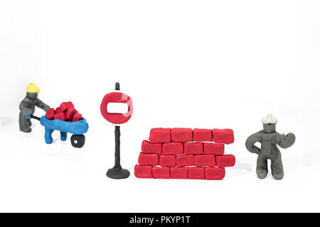 Abstract photo of buildings works. Figures made from Play Clay. Isolated on white background. Stock Photo