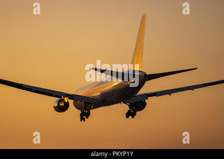 Boeing 767-300 landing to the Itami International Airport at dusk in Osaka, Japan. Stock Photo