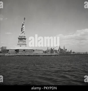 1950s, historical, the Statue of Liberty, as seen from the Hudson river, Lower Manhattan, New York, USA. The neoclassical sculpture was a gift of friendship from the French to the peoples of the USA and built by french sculptor Bartholdi, together with engineer, Gustave Eiffel, he of the iconic Paris tower. Stock Photo