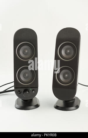 Two sound columns on white background. Pair of professional sound speakers isolated on white. Modern audio technology. Stock Photo