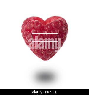 Raspberry in the shape of a heart on a white background Stock Photo