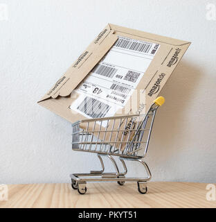 Amazon packaging in shopping trolley. Stock Photo