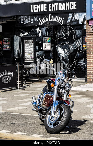 Entrance to Chinnerys music venue with electric guitar mural artwork. Gig venue exterior. Jack Daniel's brand. Motorcycle, motorbike. Rock venue Stock Photo