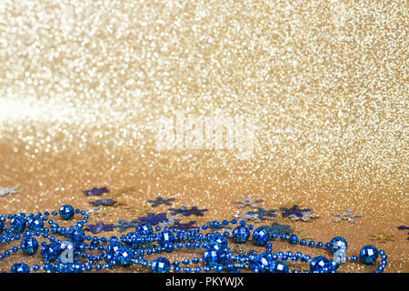 Christmas blue balls on abstract gold glitters bokeh background Stock Photo