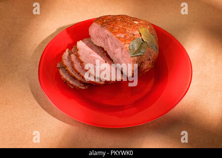 Sliced ham on a red plate. Food theme still life Stock Photo