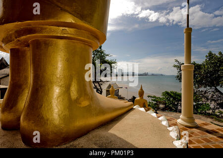 Foot of the large golden Buddha statue overlooking Hua Hin at Khao Takiab Buddhist temple Thailand S.E. Asia Stock Photo