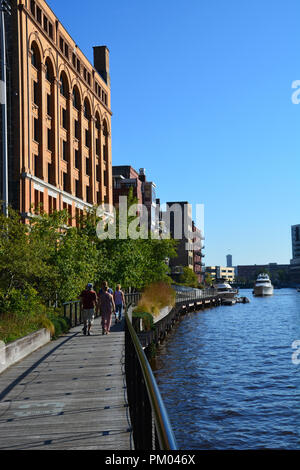 Restaurants and high end condos line the area that was once a warehouse district along Milwaukee's River Walk. Stock Photo