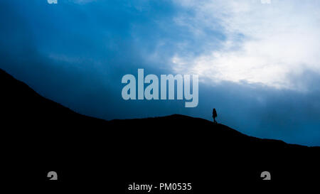 Silhouette walking on Llangynidr mountain Stock Photo