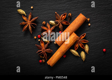 Food background close up organic various spices on black slate board Stock Photo