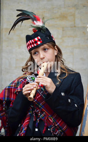 Brussels, Belgium - August 19, 2018: Young girl playing flute in Grand Place, Brussels, Belgium. Stock Photo