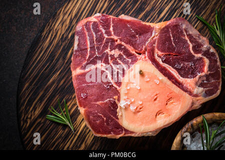 Raw beef steak osso bucco on cutting board. Stock Photo