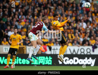 Burnley's Charlie Taylor (centre) and Wolverhampton Wanderers' Helder Costa battle for the ball during the Premier League match at Molineux, Wolverhampton. Stock Photo