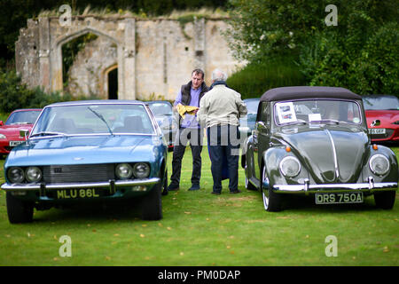 A Jensen Interceptor and a Volkswagen Beetle at a classic car gathering at Sudeley Castle in the Cotswolds. Stock Photo