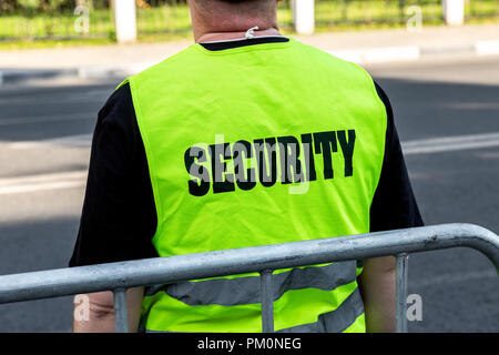 Security men with high visable green jackets standing near the border Stock Photo