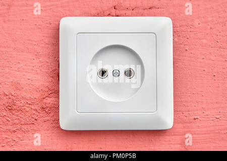 Wall electrical outlet of European type, square-shaped, white color, international plug type C, close-up. Stock Photo