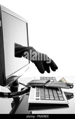 Gloved hand of a thief stealing wallet through a computer screen. Concept of internet crime. Stock Photo