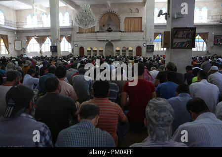 September 14, 2018 - Friday prayers takes place in the Saad mosque in the city of Idlib. During the sermon the preacher delivered a speech about the history of the Al-Assad family and how they played an important role in the decline of Syria and of the Islamic faith in the country. Idlib, which is believed to host three million Syrians, many of whom were evacuated from Eastern Ghouta, Aleppo, Deera and other former rebel-held areas, is under the control of opposition rebel groups. As it remains the latest major opposition stronghold in Syria a seemingly imminent full-scale offensive on Syria's Stock Photo