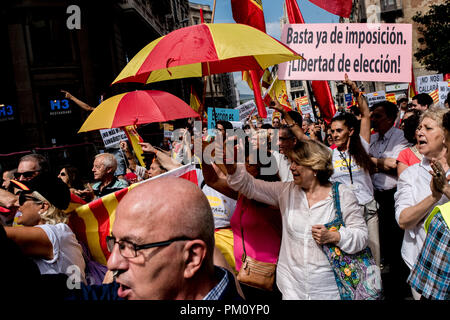 Barcelona, Spain. 16 September 2018.   Protesters called by unionist organizations hold Spanish  flags and colorful umbrellas in Barcelona. Demonstrators marched in support of the use of the Spanish language and against the Language immersion system, a technique using bilingual language education (Catalan and Spanish) in the Catalan schools. Credit:  Jordi Boixareu/Alamy Live News Stock Photo